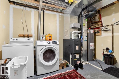 The property includes a dedicated utility area with a washer and dryer, a water heater, and a furnace - 1637 Towne Centre Boulevard, Edmonton, AB - Indoor Photo Showing Laundry Room