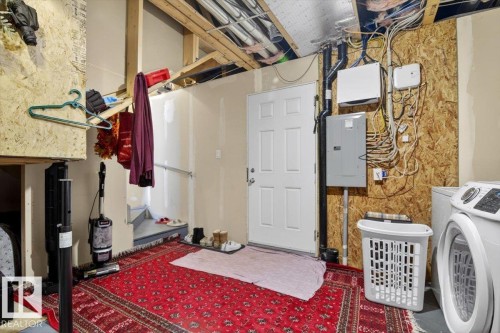 The property features a utility area with a white door, visible electrical conduits, and a washing machine - 1637 Towne Centre Boulevard, Edmonton, AB - Indoor