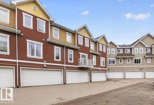 The property features a charming exterior with a blend of brown and tan siding, complemented by white window frames - 1637 Towne Centre Boulevard, Edmonton, AB - Outdoor