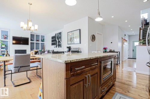 The property features an open-concept living area with light hardwood floors - 18 Enchanted Way, St. Albert, AB 