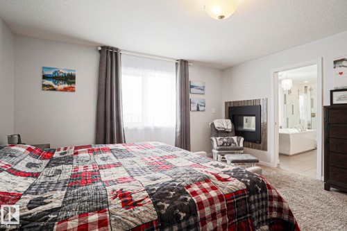 This room features neutral-toned walls, carpeting, and a window with curtains - 18 Enchanted Way, St. Albert, AB 