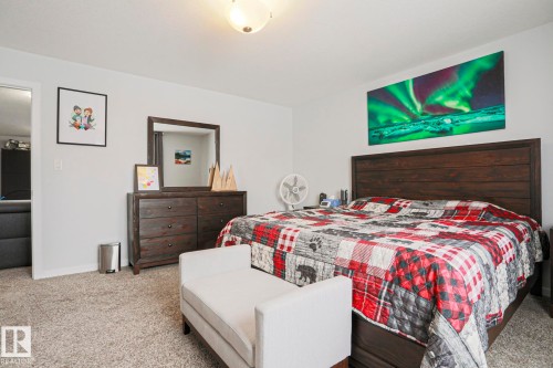 This bedroom features light-colored carpeting, white walls, and a recessed ceiling light fixture - 18 Enchanted Way, St. Albert, AB 
