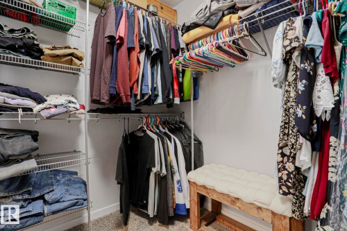 This closet features wire shelving, hanging rods, and carpeting - 18 Enchanted Way, St. Albert, AB 