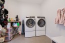 Laundry area featuring a side-by-side washer and dryer, tile flooring, and light-colored walls - 18 Enchanted Way, St. Albert, AB 