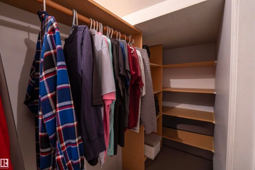 The property features a closet with a hanging rail and shelving units, providing ample storage solutions - 1728 37 Street, Edmonton, AB - Indoor With Storage