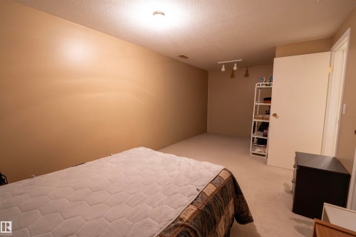 This room features soft neutral tone walls and light-colored carpeting, providing a versatile palette - 1728 37 Street, Edmonton, AB - Indoor Photo Showing Bedroom