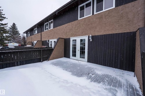 This property features a private fenced patio area with access via white French doors - 1728 37 Street, Edmonton, AB - Outdoor With Exterior