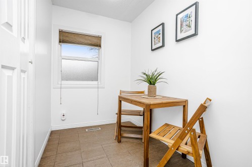This room features a window providing natural light, white walls, and tiled flooring - 6524 112 Street, Edmonton, AB - Indoor