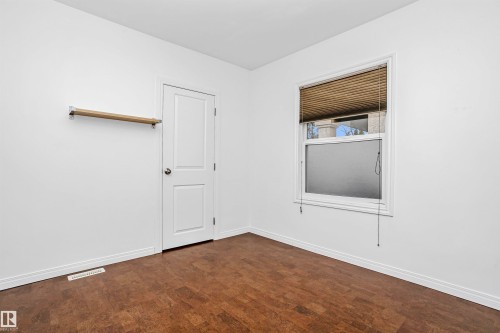 This room features warm-toned flooring, a single window with blinds, and white walls - 6524 112 Street, Edmonton, AB - Indoor Photo Showing Other Room