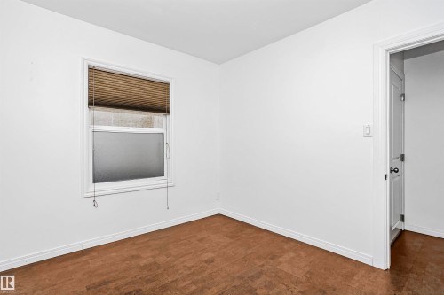 This room features light-colored walls and flooring, with a window fitted with horizontal blinds - 6524 112 Street, Edmonton, AB - Indoor Photo Showing Other Room