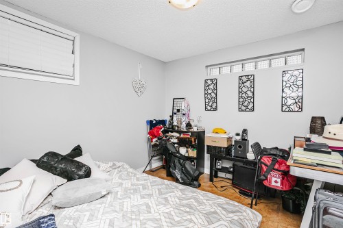 This room features light grey walls and a window with blinds, providing natural light - 6524 112 Street, Edmonton, AB - Indoor Photo Showing Bedroom