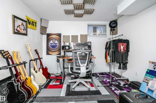 The room features white painted walls, a window with horizontal blinds, and a textured ceiling - 6524 112 Street, Edmonton, AB - Indoor Photo Showing Other Room