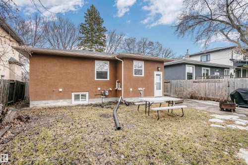 The property features a brown stucco exterior with white-framed windows - 6524 112 Street, Edmonton, AB - Outdoor