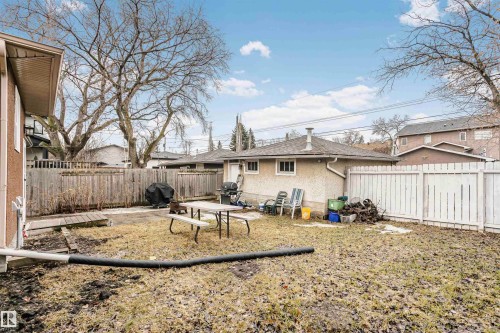 The property features a fenced yard, including a wooden fence and a white picket fence - 6524 112 Street, Edmonton, AB - Outdoor