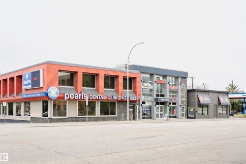 The property features a red facade with large windows and stone accents - 6524 112 Street, Edmonton, AB - Outdoor