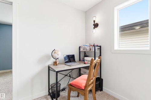 This room features a window providing natural light, light-colored walls, and carpeting - 678 Secord Boulevard, Edmonton, AB - Indoor Photo Showing Office
