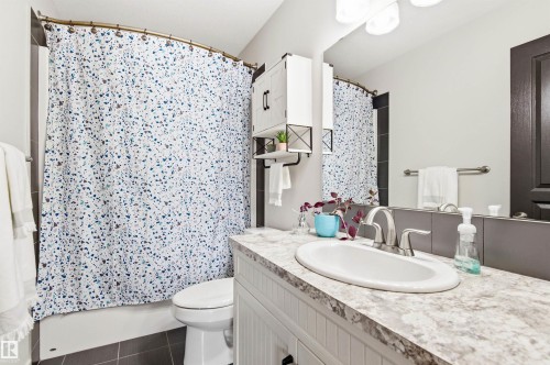 Bathroom featuring a vanity with an integrated sink and a shower-tub combination - 678 Secord Boulevard, Edmonton, AB - Indoor Photo Showing Bathroom