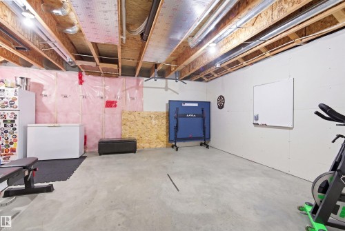 The property includes an unfinished basement with exposed wooden joists and ductwork, providing an opportunity for customization - 678 Secord Boulevard, Edmonton, AB - Indoor Photo Showing Basement