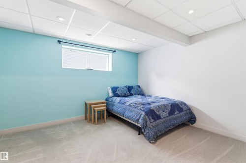 This room features light blue and white walls, a window with blinds, and recessed lighting in the ceiling - 678 Secord Boulevard, Edmonton, AB - Indoor Photo Showing Bedroom