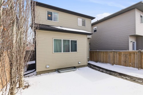 The property features a two-story exterior with horizontal siding and a dark roof - 678 Secord Boulevard, Edmonton, AB - Outdoor With Exterior