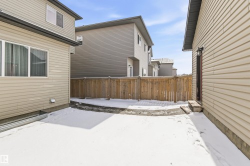 The property features an enclosed yard with a wooden fence - 678 Secord Boulevard, Edmonton, AB - Outdoor With Exterior