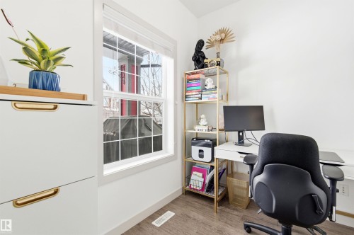 This room features a window with white trim, light-toned flooring, and white walls - 678 Secord Boulevard, Edmonton, AB - Indoor Photo Showing Office