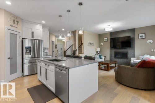 3632 Hummingbird Way, Edmonton, AB - Indoor Photo Showing Kitchen With Fireplace With Stainless Steel Kitchen With Upgraded Kitchen