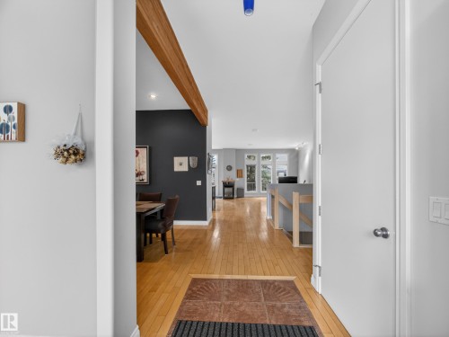 Entryway featuring light hardwood flooring, a contrasting tiled section, and a ceiling with exposed wood beams - 569 Butterworth Way, Edmonton, AB - Indoor Photo Showing Other Room