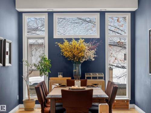 This room features striking blue walls, hardwood floors, and recessed lighting - 569 Butterworth Way, Edmonton, AB - Indoor Photo Showing Dining Room