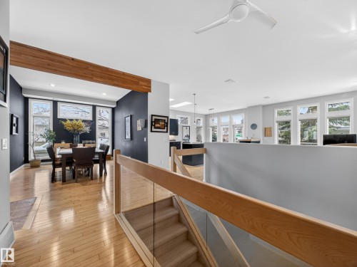 Bright open-concept living area with light hardwood floors, high ceilings, and an abundance of windows providing natural light - 569 Butterworth Way, Edmonton, AB - Indoor Photo Showing Other Room