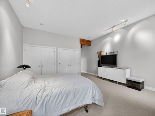 This bedroom features light-colored walls and carpeting, offering a bright and spacious feel - 569 Butterworth Way, Edmonton, AB - Indoor Photo Showing Bedroom