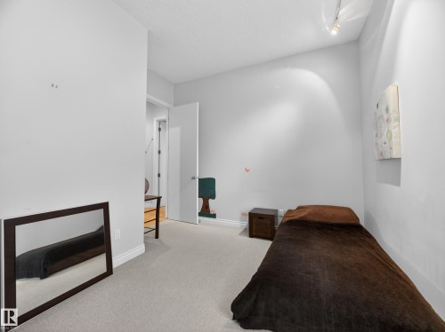 The room features light gray walls, a light-colored carpet, and a white ceiling with track lighting - 569 Butterworth Way, Edmonton, AB - Indoor