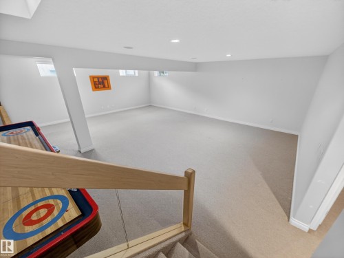 Spacious lower level with neutral carpeting and recessed lighting - 569 Butterworth Way, Edmonton, AB - Indoor Photo Showing Other Room