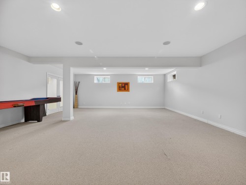 Expansive recreation room featuring light-colored carpeting, recessed lighting, and multiple windows providing natural light - 569 Butterworth Way, Edmonton, AB - Indoor