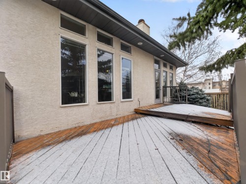 The property features a private deck, accessible via a glass panel door, with a wood surface and a railing - 569 Butterworth Way, Edmonton, AB - Outdoor With Deck Patio Veranda With Exterior