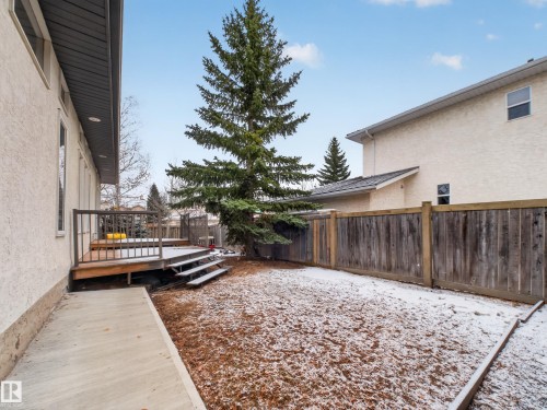 The property features a private backyard with a wooden deck, stairs, and a concrete walkway - 569 Butterworth Way, Edmonton, AB - Outdoor With Deck Patio Veranda With Exterior