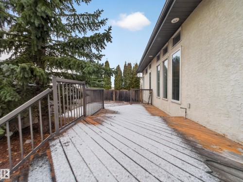 The property features a spacious deck with metal railings, offering outdoor living space - 569 Butterworth Way, Edmonton, AB - Outdoor With Deck Patio Veranda With Exterior
