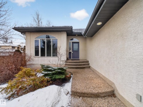 The property features an arched entry door and a large arched window - 569 Butterworth Way, Edmonton, AB - Outdoor