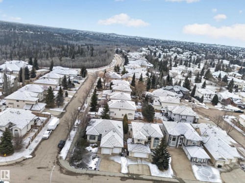 This aerial view showcases a residential area with a collection of properties, each featuring a pitched roof and a driveway - 569 Butterworth Way, Edmonton, AB - Outdoor With View