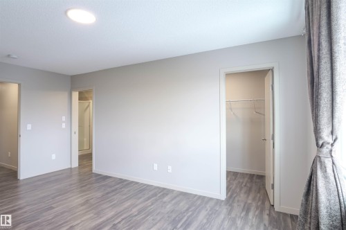 The property features a closet with white wire shelving and grey flooring - 1426 25 Avenue, Edmonton, AB - Indoor With Storage