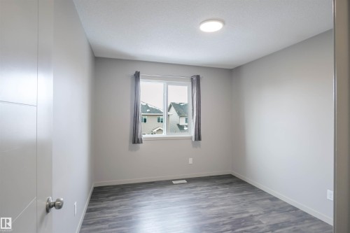 Dedicated laundry area featuring a countertop and wire shelving for storage - 1426 25 Avenue, Edmonton, AB - Indoor Photo Showing Laundry Room
