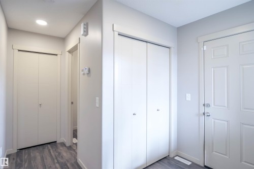 This room features grey walls, a window with grey curtains, and dark wood-style flooring - 1426 25 Avenue, Edmonton, AB - Indoor Photo Showing Other Room