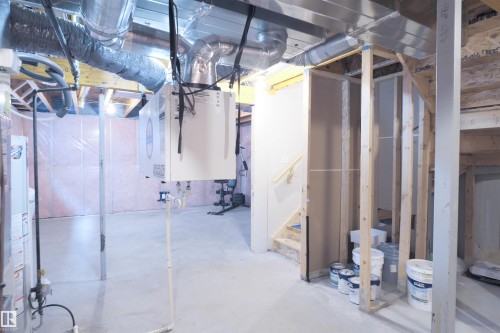 Spacious unfinished lower level with exposed ductwork, structural framing, and a staircase - 1426 25 Avenue, Edmonton, AB - Indoor Photo Showing Basement