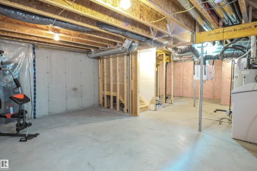 The property features an unfinished basement with exposed wooden joists and concrete flooring, offering substantial potential for customization - 1426 25 Avenue, Edmonton, AB - Indoor Photo Showing Basement