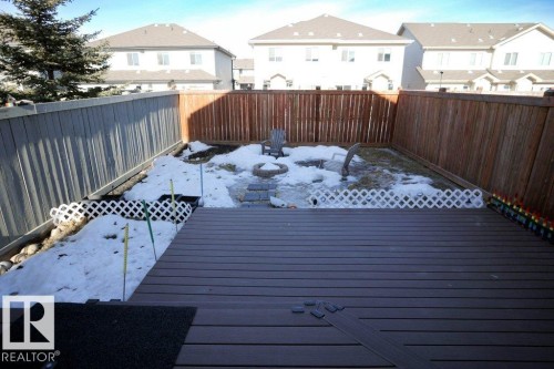 The property features a spacious deck with dark grey decking, leading to an enclosed yard - 1426 25 Avenue, Edmonton, AB - Outdoor With Deck Patio Veranda With Exterior
