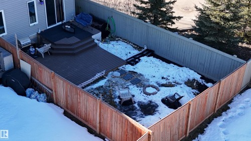 The property features a fenced yard, a multi-level deck, and a fire pit area - 1426 25 Avenue, Edmonton, AB - Outdoor With Deck Patio Veranda With Exterior