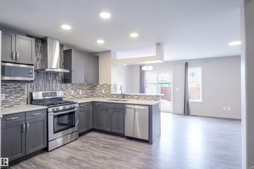 Entryway featuring a panel door, light gray walls, recessed lighting, and a closet with bi-fold doors - 1426 25 Avenue, Edmonton, AB - Indoor Photo Showing Other Room