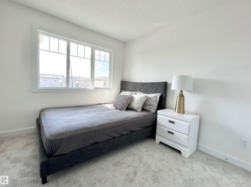 Bedroom featuring light carpet and a textured ceiling - 19634 29 Avenue, Edmonton, AB - Indoor Photo Showing Bedroom