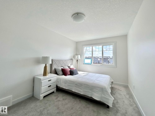 Bedroom featuring a textured ceiling and light colored carpet - 19634 29 Avenue, Edmonton, AB - Indoor Photo Showing Bedroom