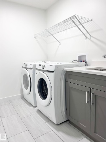 Laundry room featuring washing machine and dryer and cabinet space - 19634 29 Avenue, Edmonton, AB - Indoor Photo Showing Laundry Room